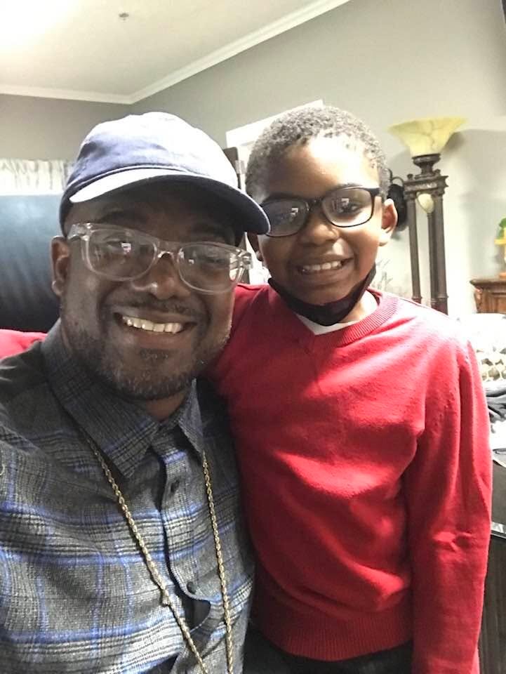 Bishop G. F. Austin III with his son at home